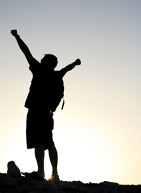 Guy Celebrates after Climbing a Mountain