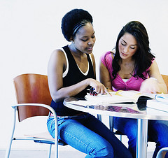 students sharing their textbooks